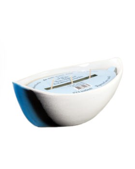 Scented candle in a ceramic boat