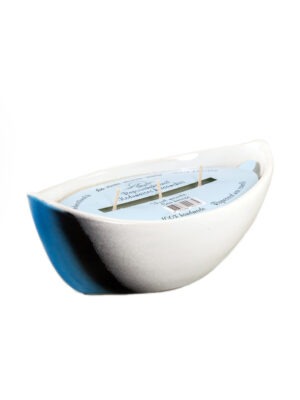 Scented candle in a ceramic boat